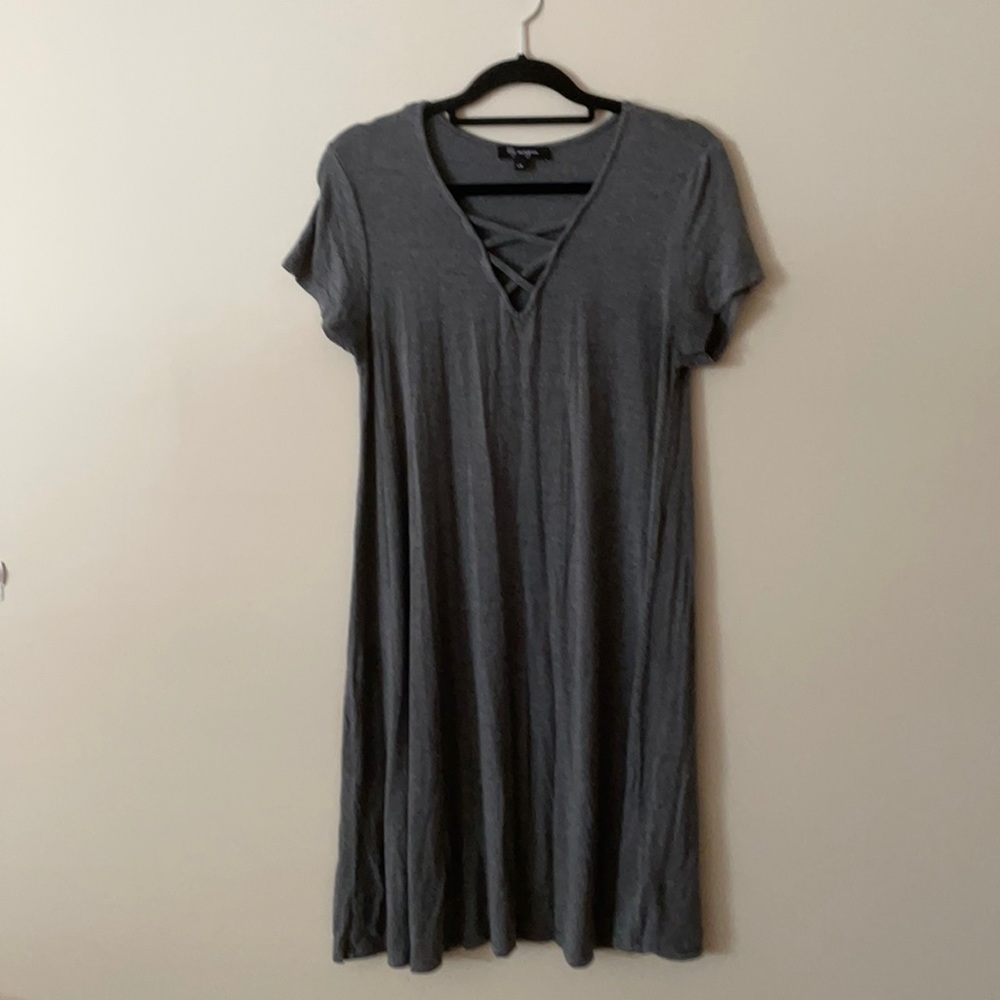 Knee length grey dress with neckline details.